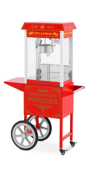 Rode popcornmachine op een kar met grote wielen en glazen vensters.